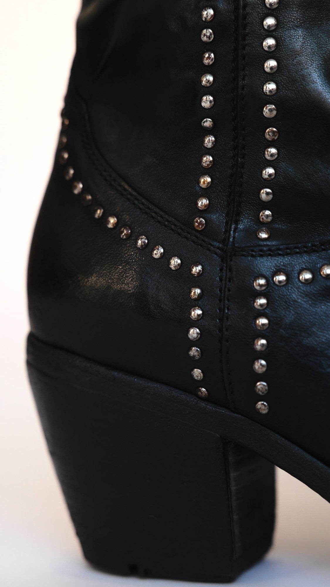 The black Studded Western Ankle Boot, the heel and the metal stud trim along the seams, at Madison Maison
