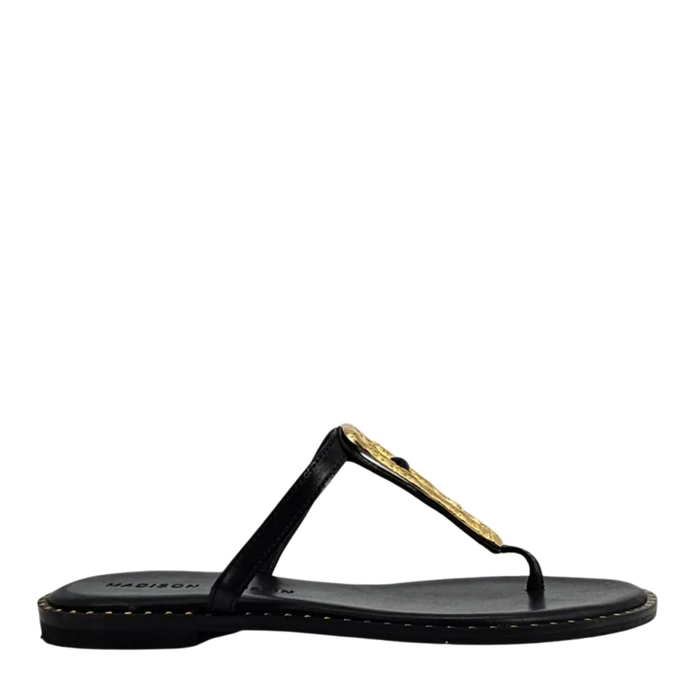 Black leather flat thong sandal with hammered gold link ornament and stitched sole edge