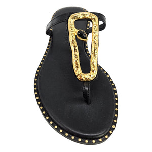 Black leather flat sandal with hammered gold link buckle and T-strap thong