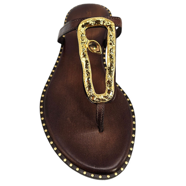 Brown leather thong sandal with gold hammered U-link ornament and studded trim