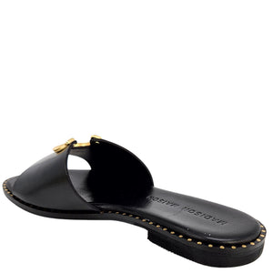 Black leather flat sandal with open toe and gold horseshoe buckle