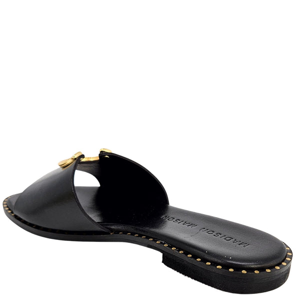 Black leather flat sandal with open toe and gold horseshoe buckle