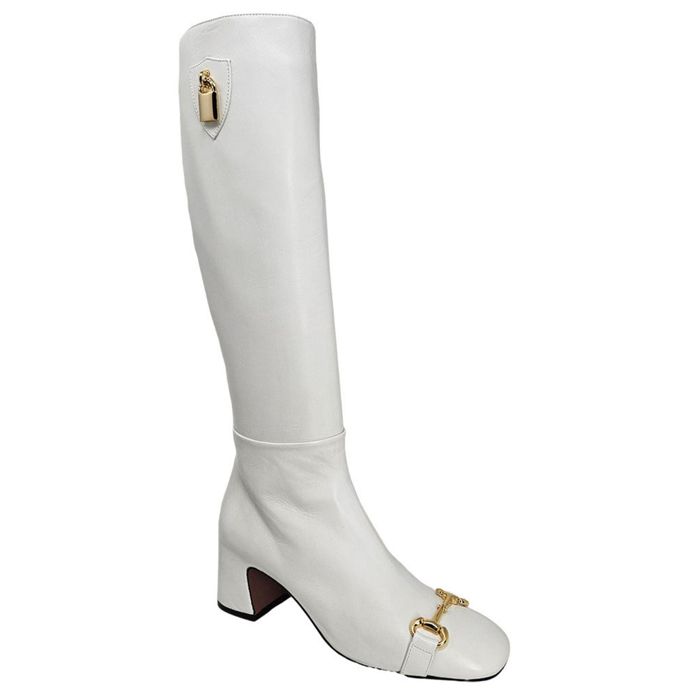 White tall boot with gold lock ornament and low block heel