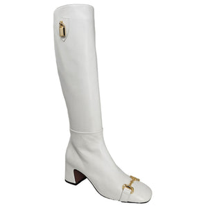 White tall riding boot with gold buckle detail and low block heel
