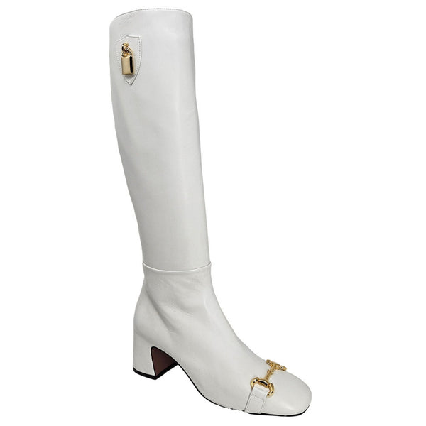 White tall riding boot with gold buckle detail and low block heel