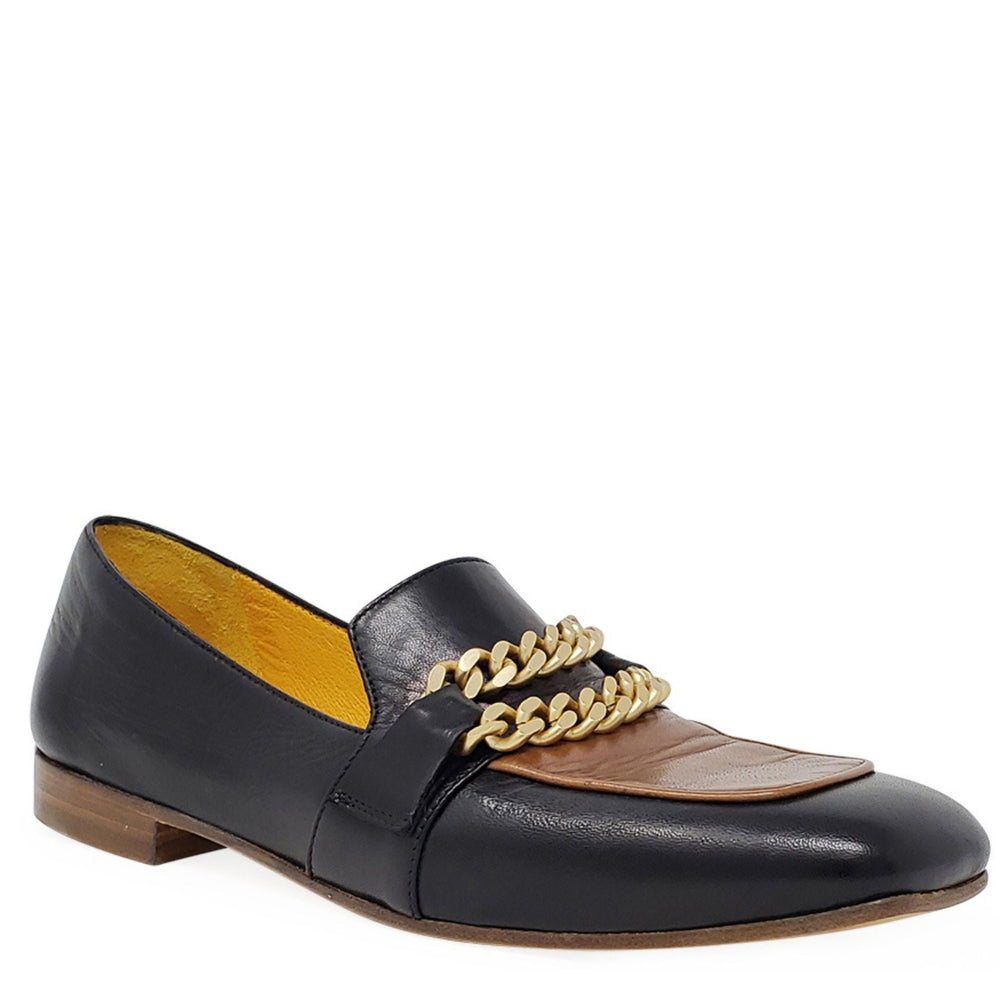 Black flat loafer with tan lining, gold chain detail, and low wood-look heel.