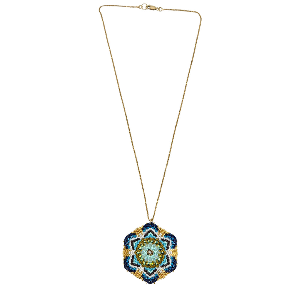 Gold-tone beaded pendant necklace with small blue mandala flower drop