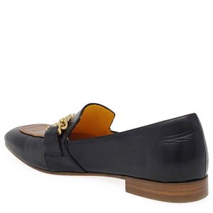 Black loafer with tan footbed and gold chain detail; brown sole and low heel.