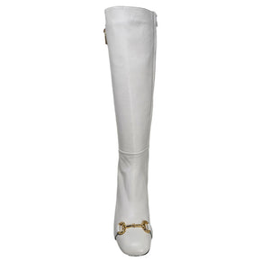 White tall boot with gold horseshoe buckle at ankle and low sole
