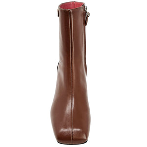 Brown leather ankle boot with side seam and block heel; red lining shows at opening.