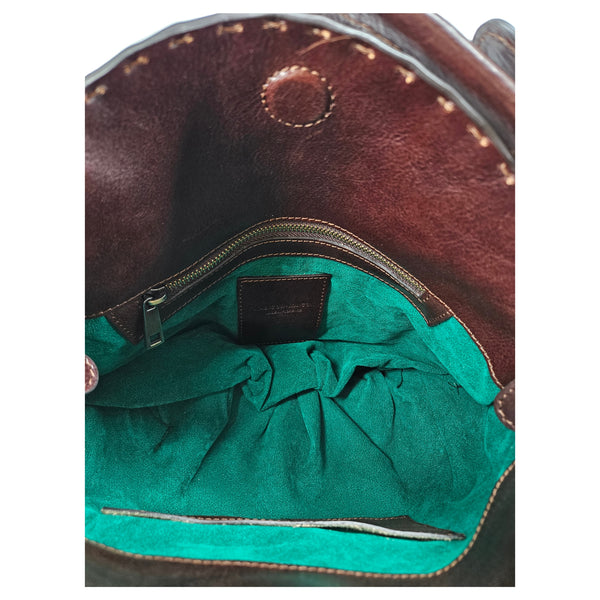 Leather star shoulder bag interior with teal lining and zip-top pocket