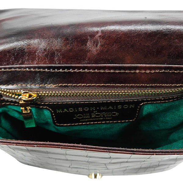 Croc-embossed leather crossbody bag interior with zip pocket and brand label