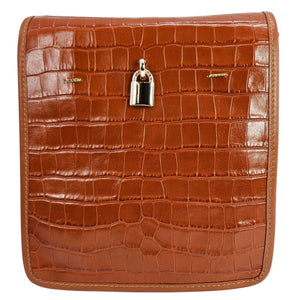 Tan croc-embossed leather crossbody bag with top flap and silver clasp lock