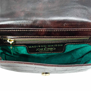 Small crossbody bag interior with logo label and green fabric lining