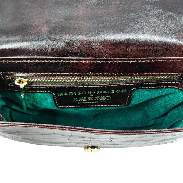 Small crossbody bag interior with logo label and green fabric lining
