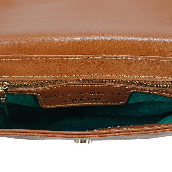 Inside view: tan bag with green fabric lining and zipper compartment