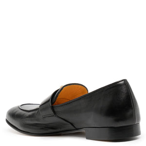 Black leather flat loafer, side profile with amber insole lining