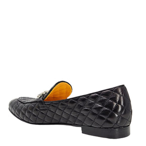 Quilted black flat loafer with yellow-lined interior and slip-on upper