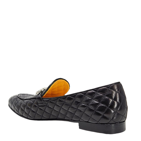 Quilted black flat loafer with yellow-lined interior and slip-on upper
