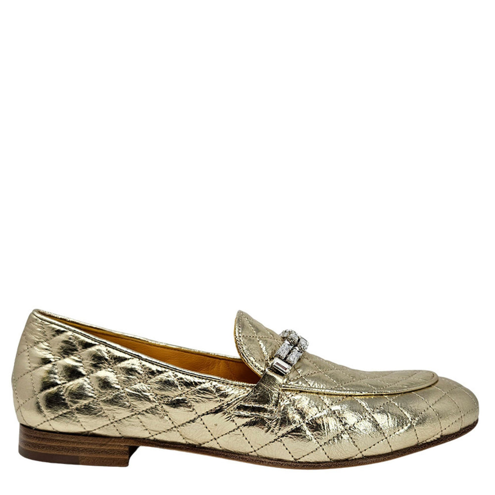 Gold quilted flat loafer with jeweled buckle ornament and low brown sole