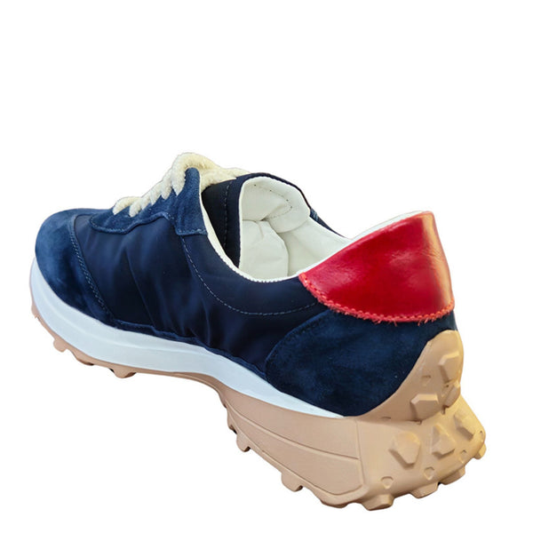 Navy jogger sneaker with red rear panel, cream laces, white lining, tan tread sole