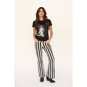 Black graphic T-shirt with red and white artwork, worn by a model with dark hair