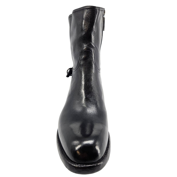 Mid-calf leather boot toe view with glossy dark finish and low sole