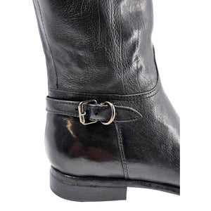 Mid-calf leather boot ankle strap with metal buckle on dark leather