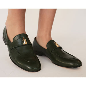 Dark green leather flat loafer with gold lock hardware and low block heel