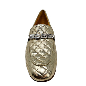 Gold quilted flat loafer with decorative jeweled buckle on the vamp