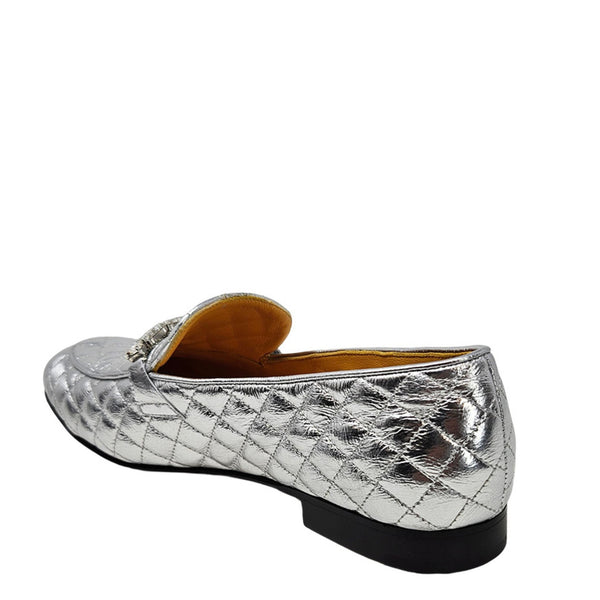 Quilted metallic silver loafer side view with slip-on upper and low block heel