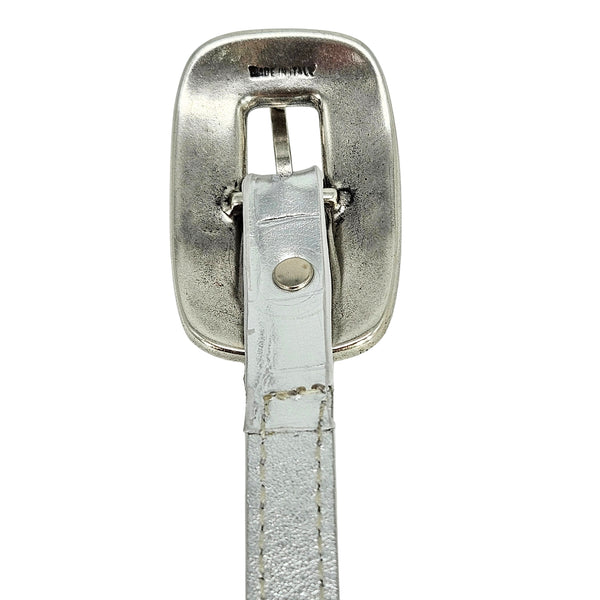 Silver belt buckle reverse with metal plate and attached leather strap