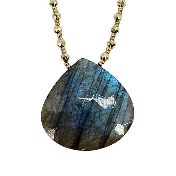 Blue labradorite teardrop pendant on gold beaded chain, detailed close view