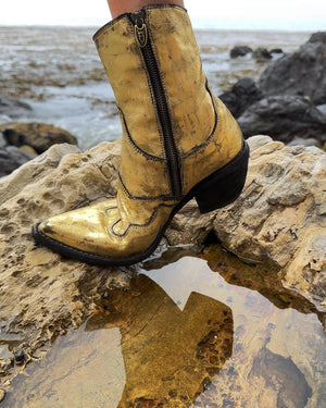 Gold laminated ankle boot with black block heel and side zipper, western stitching