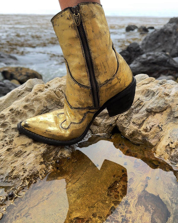 Gold laminated ankle boot with black block heel and side zipper, western stitching