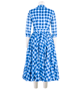Blue-and-white gingham midi dress with long sleeves, gathered back, and tie waist
