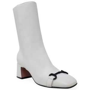 White leather mid-calf boot with black low heel and decorative front strap