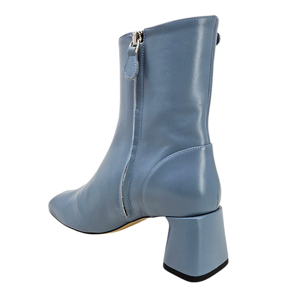 Light blue ankle boot with side zipper, block heel, and pull-on shaft.