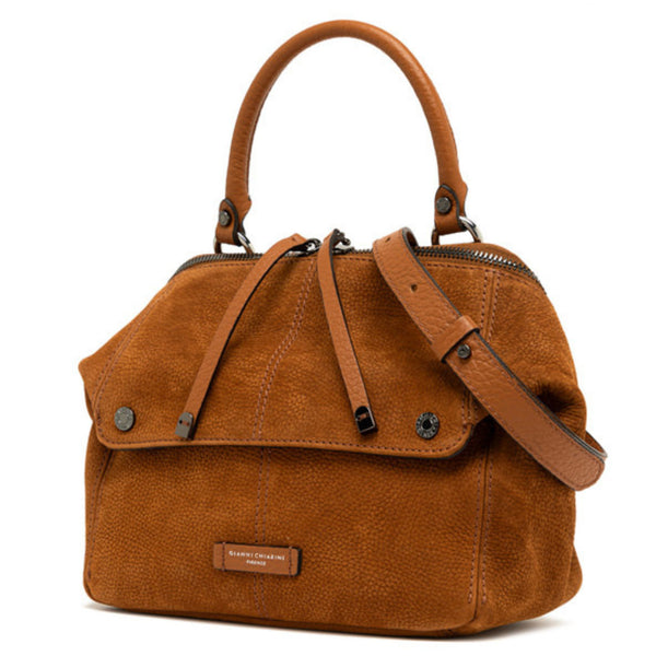 Brown leather handbag with braided strap closure and front hardware studs