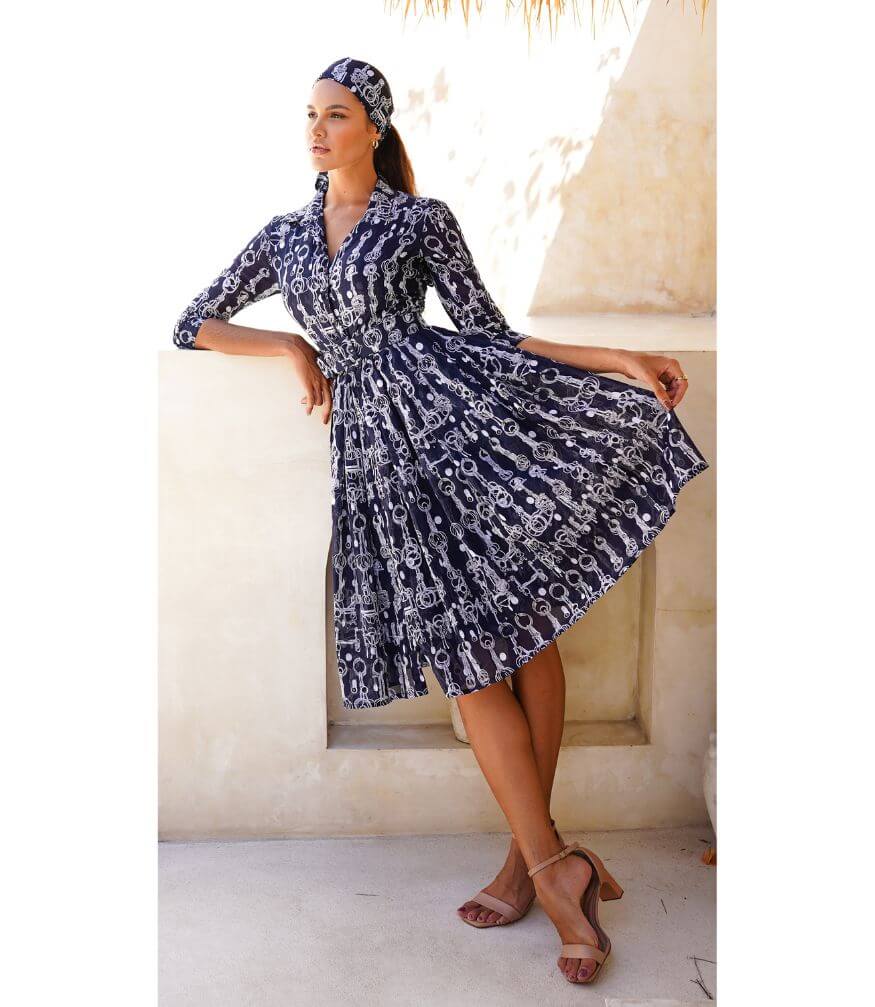 Indigo long-sleeve dress with white chain print, gathered waist, tiered skirt