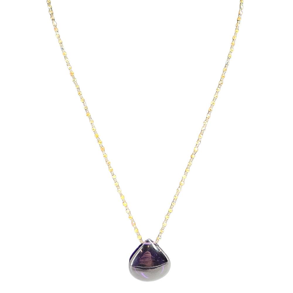 Teardrop pendant necklace featuring a purple gem drop framed in metal on chain