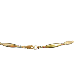 Reversible crescent necklace close-up of gold clasp with multicolor shell accents