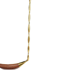 Reversible crescent necklace partial view: gold links with wood inlay crescent