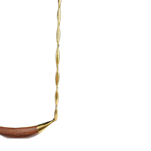 Reversible crescent necklace partial view: gold links with wood inlay crescent