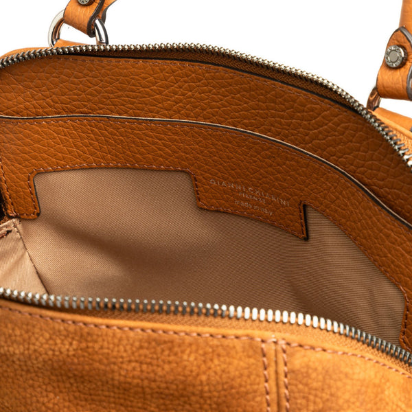 Brown leather handbag interior view with fabric lining and zipper pocket