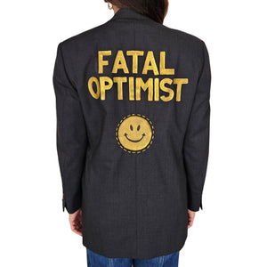 Charcoal blazer with 'FATAL OPTIMIST' graphic and smiley on back
