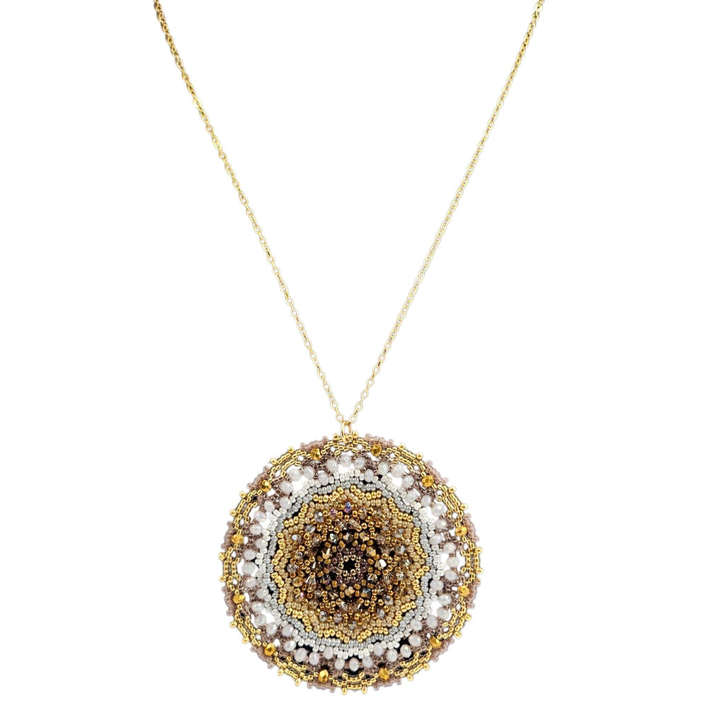 Gold-tone beaded circular pendant necklace with white accents and dark center