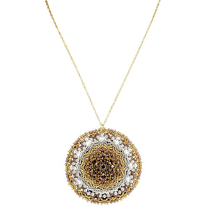 Gold-tone beaded circular pendant necklace with white accents and dark center