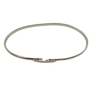 Silver coiled stretch belt with small rectangular buckle at center