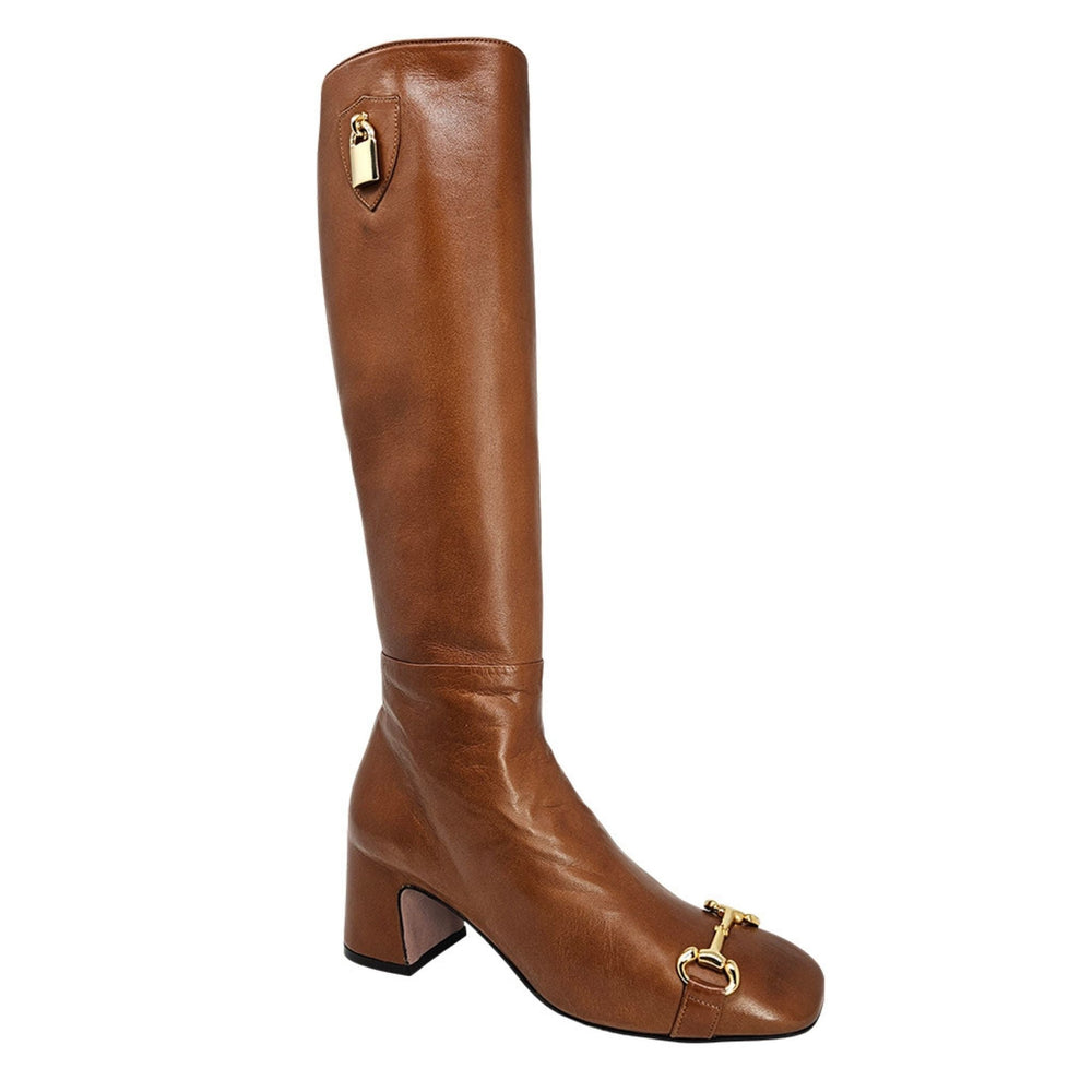 Cognac tall heeled lock boot with front buckle and lock pull detail on shaft